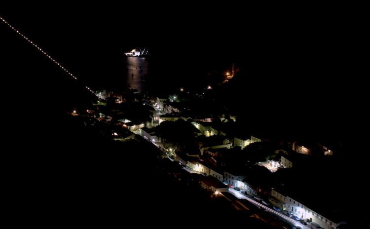 Jamestown at Night. Showing Jacobs Ladder rising steeply to the left ad the RMS St Helena anchored in James Bay